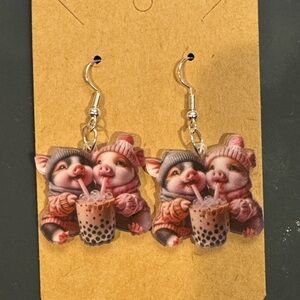 Two warm piggies sharing a boba tea earrings
